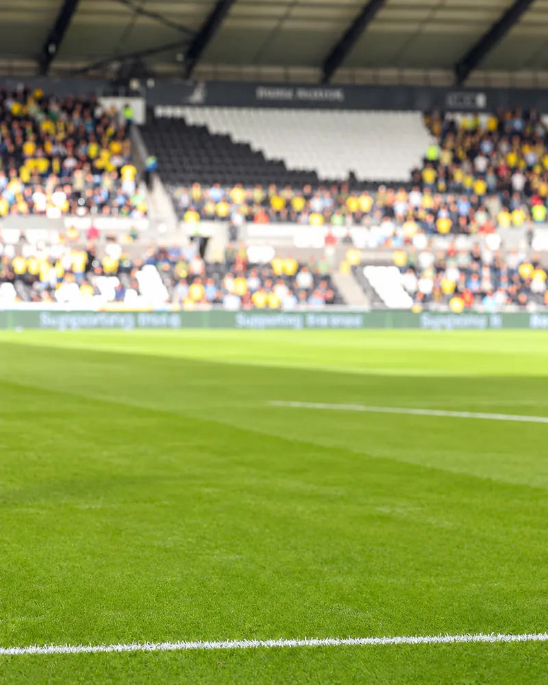 A Swansea City player in the home shirt celebrating in front of the crowd