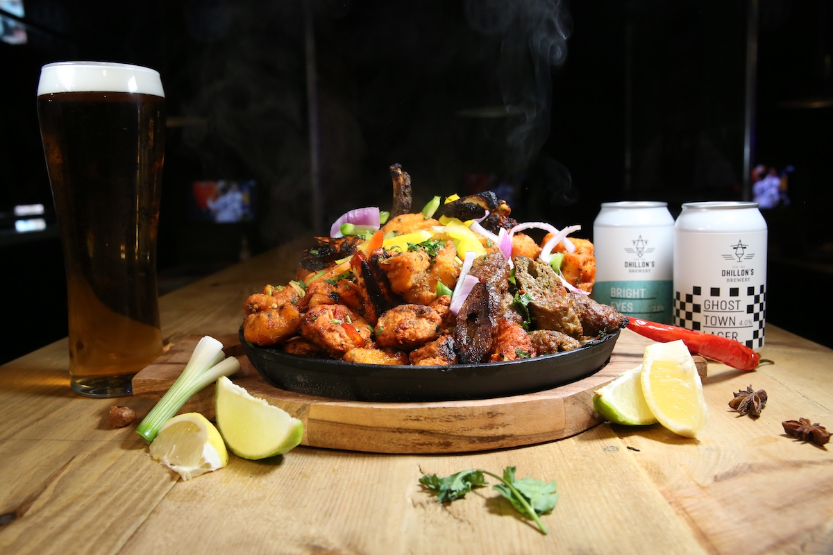 A sizzling mixed grill with a pint of lager and two cans of Dhillon’s lager